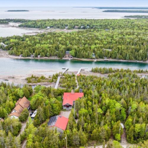 This striking aerial view reveals the unmatched privacy of 45-Degrees North, nestled in the heart of the Bruce Peninsula’s wild beauty. Surrounded by forest and water, it’s your own secluded slice of paradise.