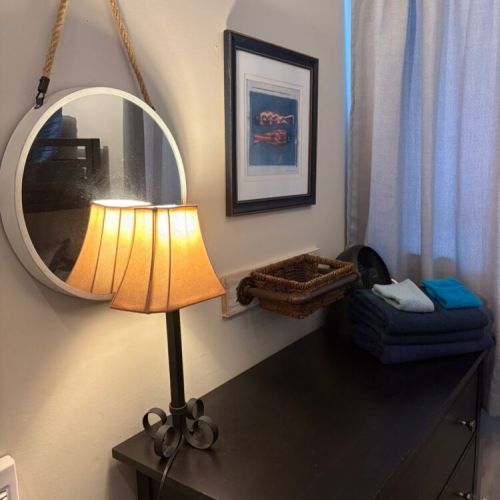 A cozy bunk room features a dresser, soft lighting, and thoughtful storage. Ideal for families and group travel seeking comfort and convenience.