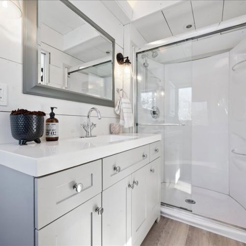 Bright, modern bathroom with a spacious vanity and walk-in shower. Clean finishes and plenty of room to get ready comfortably during longer stays.