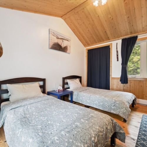 Bedroom 2: Private bedroom with direct walkout to the balcony—enjoy fresh air and lake views anytime.