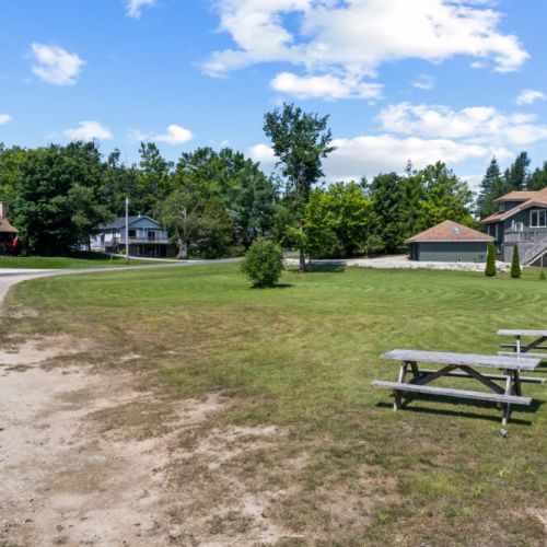 Open green space surrounds the nearby public lake access.