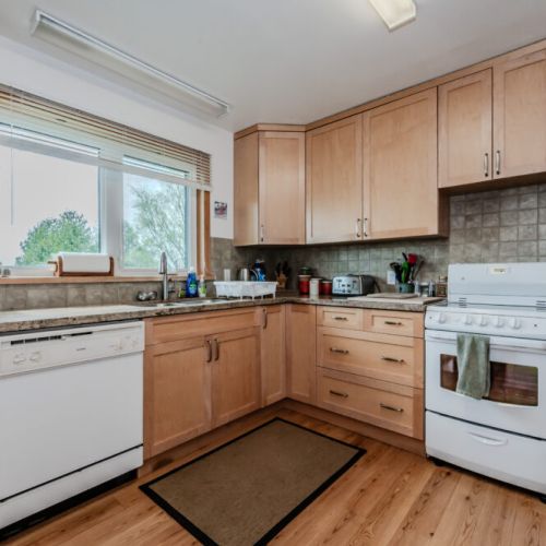Spacious kitchen with large windows, ample counter space, and everything you need to prepare meals during your lakeside stay.