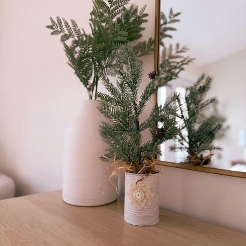 A warm winter welcome, styled with simple greenery and peaceful cottage light.