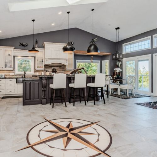 Chef-style kitchen with island seating and forest views—ideal for cooking, gathering, and enjoying your stay. A bright, open vacation rental with all the comforts of home.