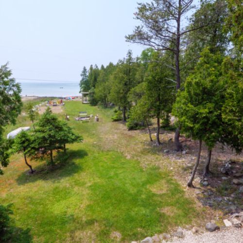The expansive and neatly landscaped yard has plenty of space for fun and games.