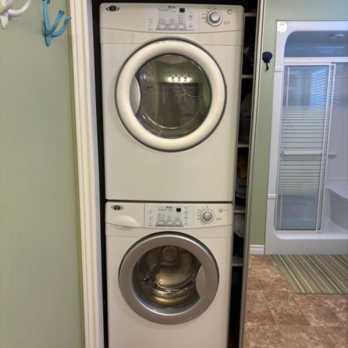 Convenient in-cottage laundry with stacked washer and dryer for longer stays.