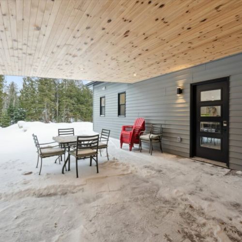 Covered patio seating area perfect for outdoor dining, relaxing, or enjoying fresh air year-round.