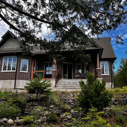 Exterior view surrounded by mature trees, providing privacy and a natural setting