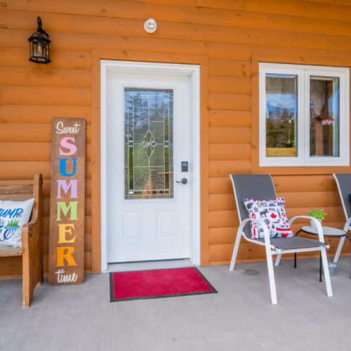 The porch features additional seating and a barbecue grill, providing a perfect spot for outdoor dining and relaxation.