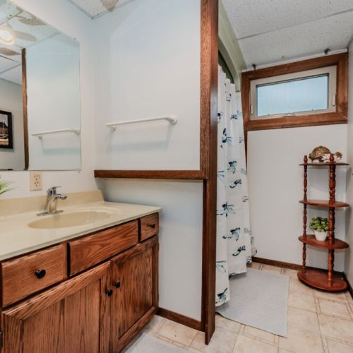 Full bathroom with shower – a convenient amenity for families enjoying a lakeside vacation escape.