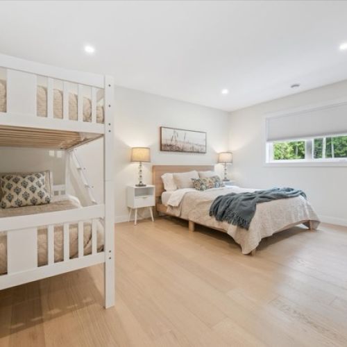 A spacious room with a queen bed and twin bunks—perfect for kids or a small family to share.