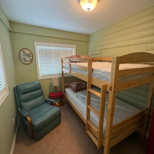 Bunk room with extra sleeping space, great for kids or additional guests.