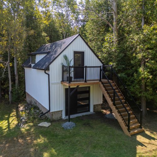 The separate loft building offers extra space and privacy tucked into the trees.