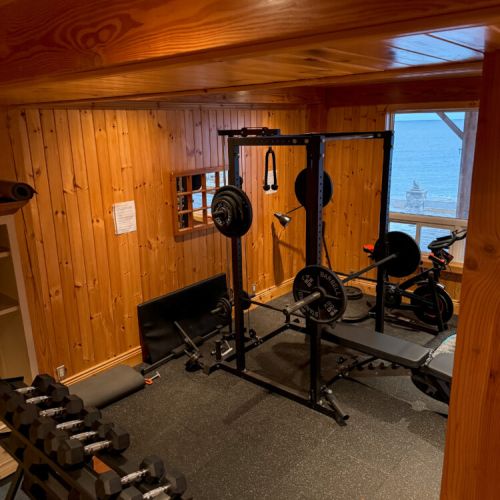 Stay active with a fully equipped gym featuring weights, bench, and a lake view—perfect for fitness-focused vacations, extended stays, and wellness retreats.