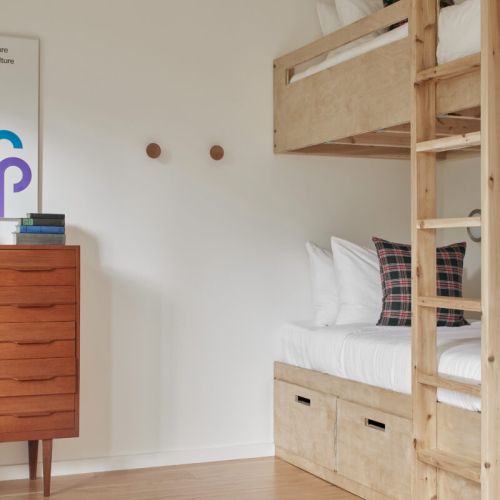A cozy bunk room with wooden built-in beds, ideal for families or groups.