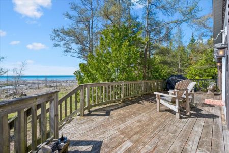 Step outside onto the expansive deck and take in the fresh lake breeze, with plenty of space to unwind and enjoy the natural setting.