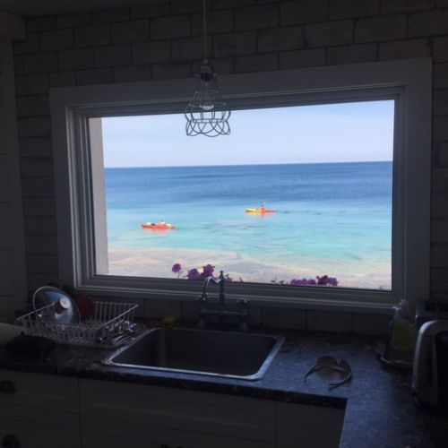 Morning coffee never looked better with kayaks on the water.