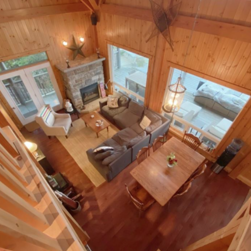 An overhead perspective of the living and dining space, beautifully designed to complement the natural surroundings and capture every ray of light.