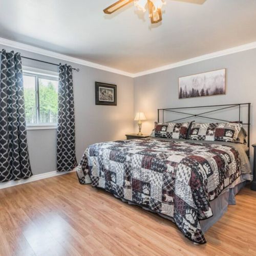 The Master bedroom features a dedicated work area, ensuite bathroom, and a treadmill. All linens and towels are supplied.