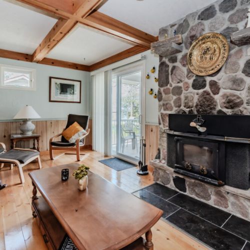 Highlighting the inviting stone fireplace, this living area is designed for comfort. Enjoy the warmth and cozy up with a good book or engage in meaningful conversations with loved ones.