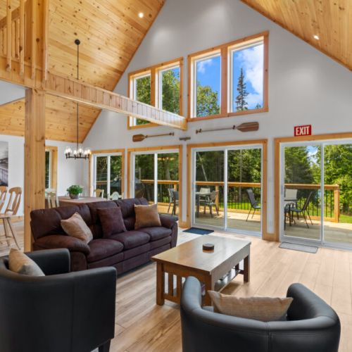 Unwind in the sun-filled great room with stunning windows overlooking the surrounding nature.