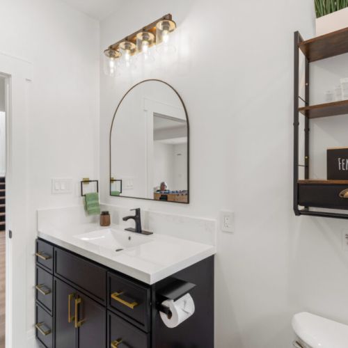 A stylish vanity offers plenty of counter space to make getting ready easy.