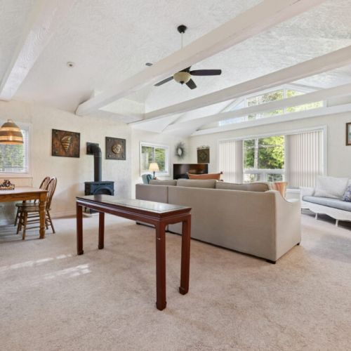 Cozy lounge area with a sectional and large windows that bring in lots of natural light.