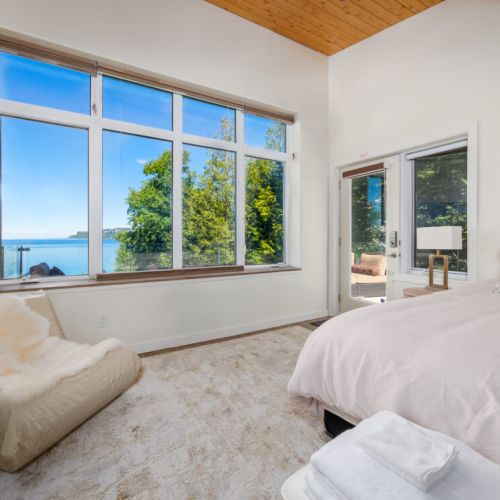 Large windows and direct access to the outdoor terrace let you enjoy the beauty of the waterfront from your bedroom.