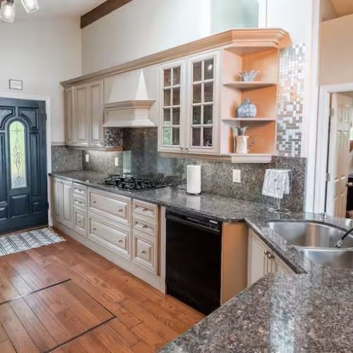 Another view of the fully equipped kitchen, showing its expansive counter space, modern appliances, and stylish open-concept design. Whether you’re whipping up breakfast or hosting a family-style dinner, this kitchen has everything you need.
