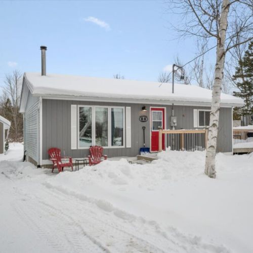 Private, welcoming entrance with a bright red door and easy year-round access.