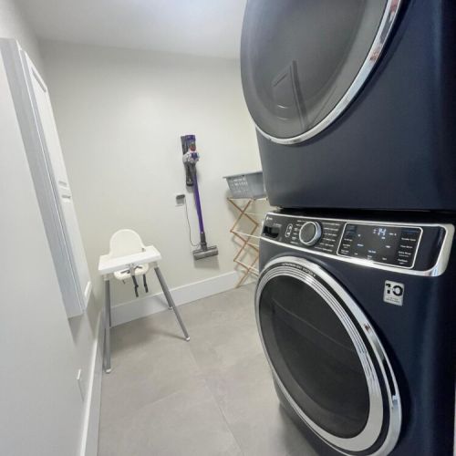 Fully equipped laundry room with high-efficiency washer and dryer, perfect for extended stays and family vacations.