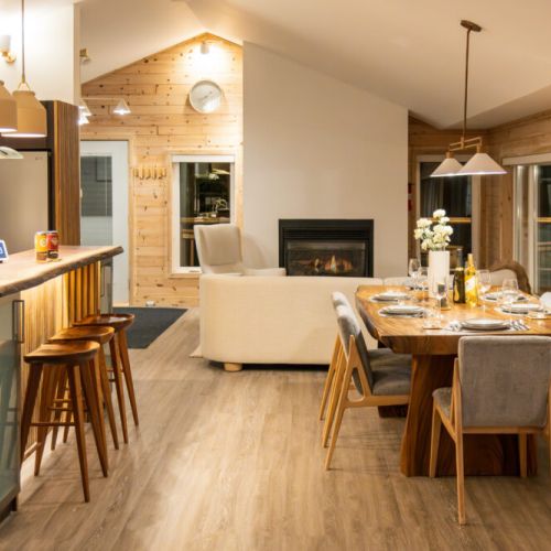 Expansive Living Spaces: Enjoy the open-concept living area with a cozy fireplace, a spacious dining table, and a fully-equipped kitchen.