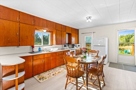 The spacious farmhouse kitchen and dining area offers plenty of room to prepare meals and gather together.