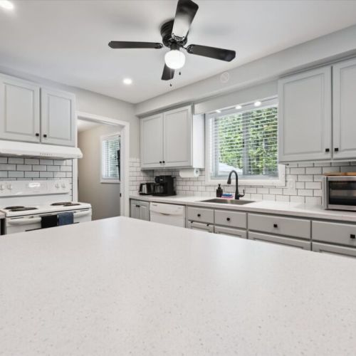 Stylish and spacious kitchen with stainless steel appliances and ample counter space for cooking together.