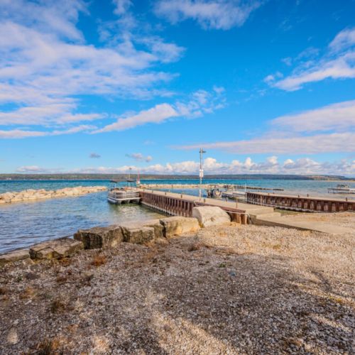 A sturdy wooden pier providing easy access to the lake, perfect for docking boats or taking a leisurely stroll over the water.