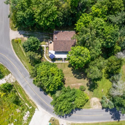 A bird's-eye view of the cottage surrounded by peaceful Bruce Peninsula forest.