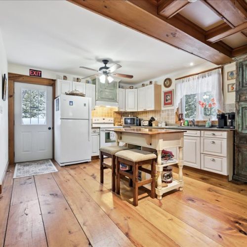 Bright, fully equipped kitchen with rustic charm, open to the dining area for easy entertaining.