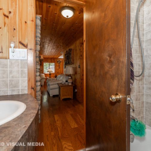 Bright and clean bathroom with a full tub and shower — conveniently located off the main living area.