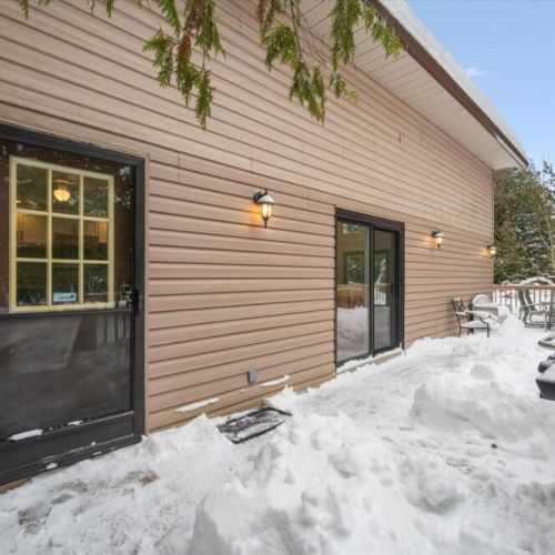 Ground-level exterior entrance with easy access and deck lighting for evening use