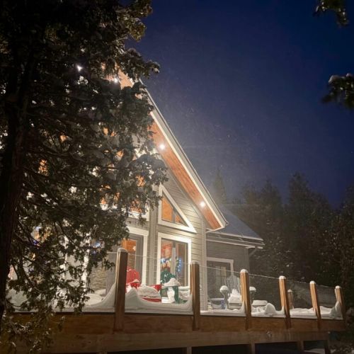 Relax on the spacious wrap-around deck, featuring Muskoka chairs and outdoor seating—an inviting space for sunsets, fresh air, and year-round lake views.