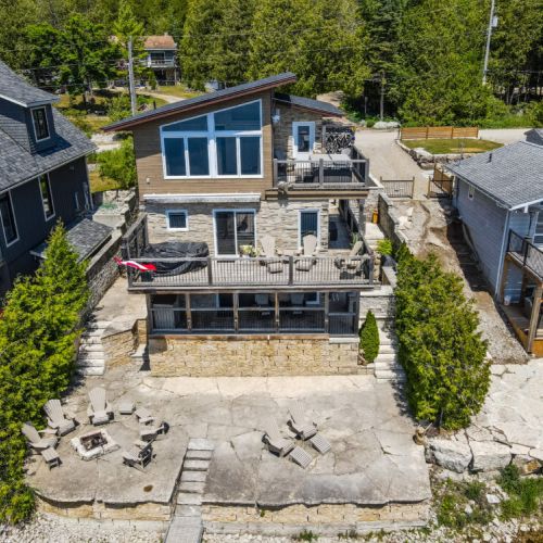 Escarpment Edge Retreat from the water—three levels of decks, stunning stonework, and unbeatable Georgian Bay views.