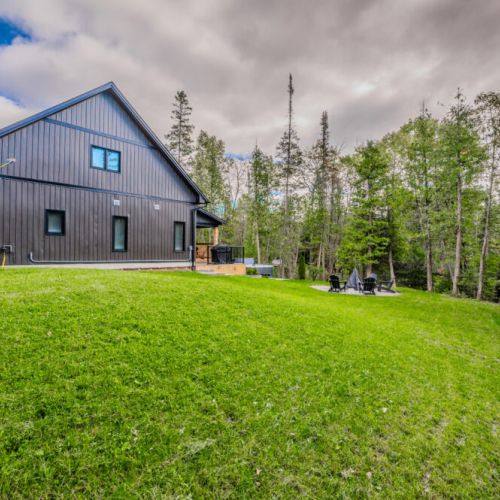 Enjoy the large backyard surrounded by nature, complete with a fire pit for cozy evenings under the stars.