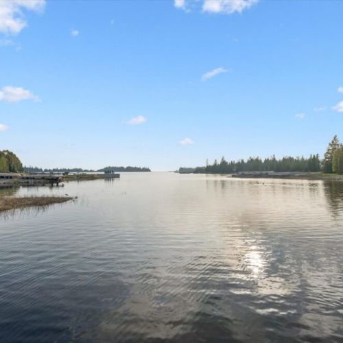 Peaceful waterfront views stretch out in every direction from this private shoreline retreat.