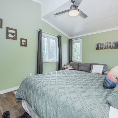Bedroom 2: Inviting bedroom with natural light and a cozy lounge space.