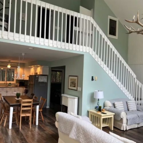 An inviting open-concept space where the kitchen, dining, and living areas flow together seamlessly — perfect for sharing meals, playing games, or simply relaxing by the fire.