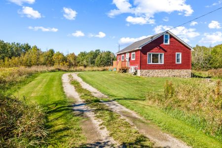 Follow the private country drive to Smith Homestead, surrounded by open fields and peaceful Bruce Peninsula scenery.