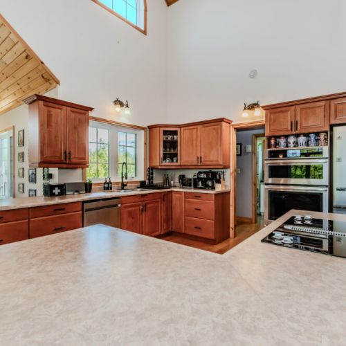 Fully equipped kitchen with stainless steel appliances and ample prep space for group gatherings.