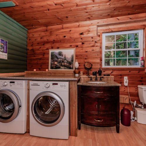 Enjoy the convenience of home at this rustic log cabin vacation rental featuring in-suite laundry, a bathroom, and woodland views—perfect for extended stays, family vacations, and relaxed nature escapes.