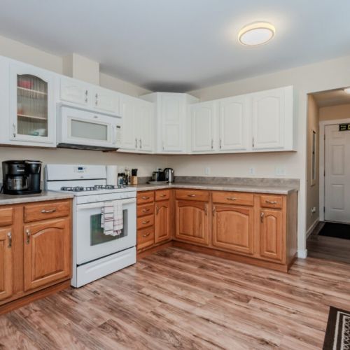 The bright and open kitchen, complete with all the essential appliances, provides plenty of room to cook and enjoy family meals at the adjacent dining table.