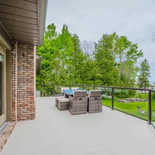 Private upper deck with cushioned seating and lush tree views—ideal for your morning coffee or evening wine under the stars.